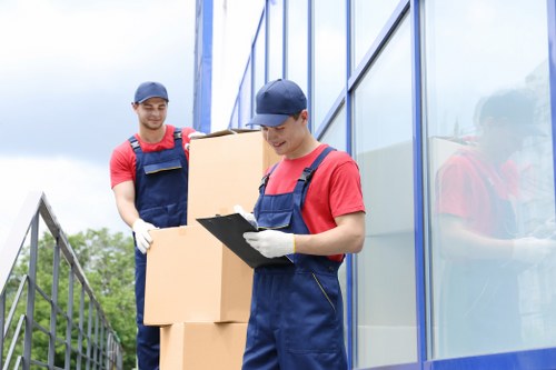 Acton business move preparation with labeled boxes and office equipment