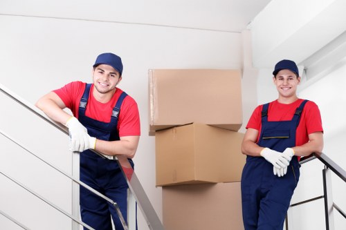 Removal team planning a flat move in Acton with boxes and furniture
