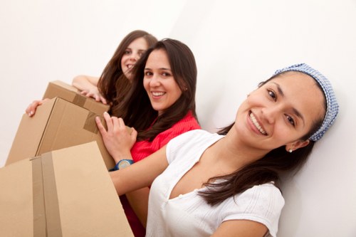 Packed boxes and wrapped furniture ready for flat removals in Acton