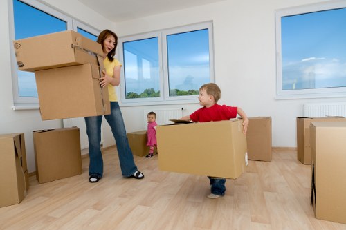 Office moving process with labelled boxes and furniture setup for an Acton business
