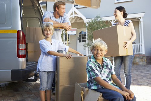 Removal van and moving team in Acton residential street