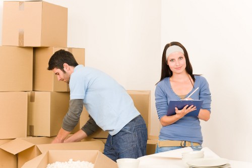 Moving furniture through a shared stairwell in an Acton apartment building