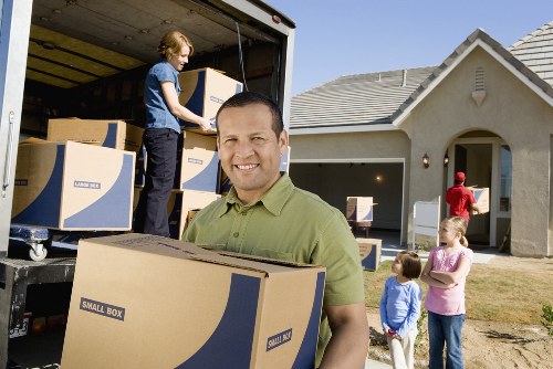 Local moving team preparing furniture for transport in Acton